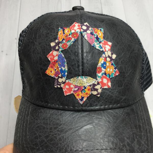 Brimfield Awakening Bitty Star appliqued on a hat by Katy Sakash