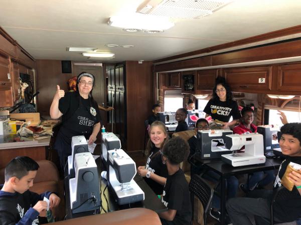 Sewing machines and kids on a Creativity Shell bus