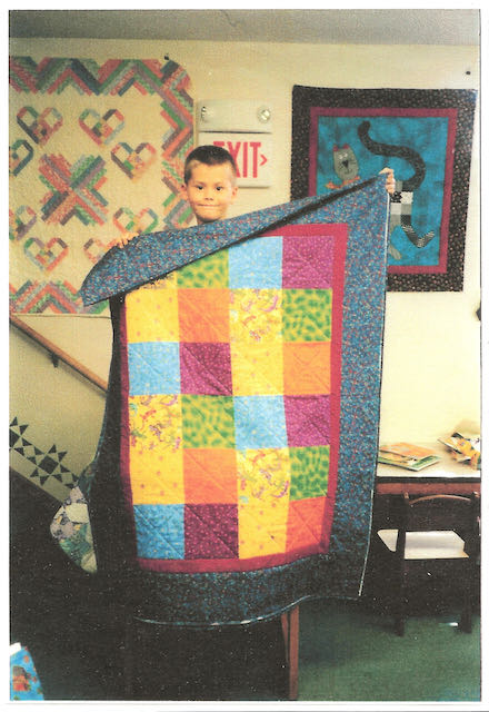 Doug Leko age 8 and first quilt